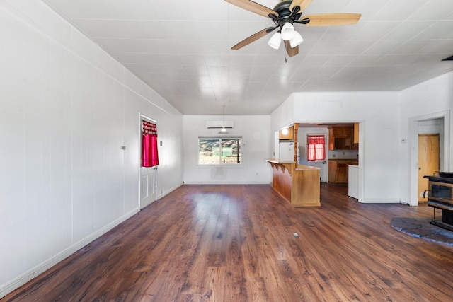 18555 Live Oak Rd, Red Bluff, CA 96080 - unfurnished living room with dark wood-style flooring, a wood stove, ceiling fan, and baseboards