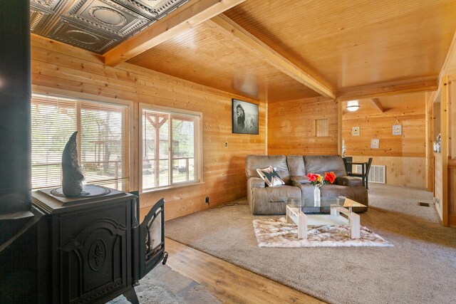27339 Hobart Rd, Shingletown, CA 96088 - living area featuring a wood stove, wooden walls, beam ceiling, wood ceiling, and wood finished floors