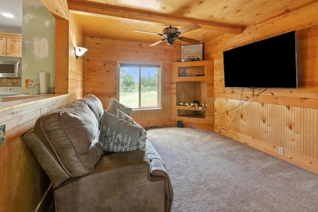 27339 Hobart Rd, Shingletown, CA 96088 - carpeted living room featuring wooden walls, beam ceiling, wooden ceiling, and a ceiling fan