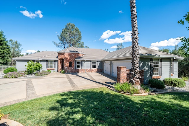 ranch-style home with concrete driveway, an attached garage, a front yard, brick siding, and a tile roof