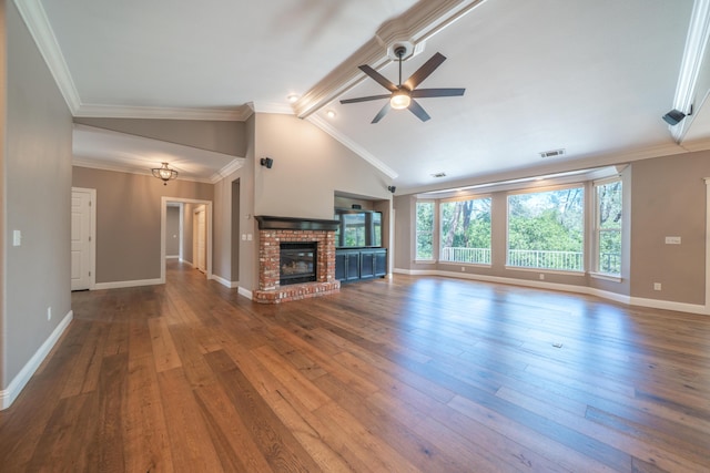 unfurnished living room with a ceiling fan, wood-type flooring, baseboards, a brick fireplace, and crown molding
