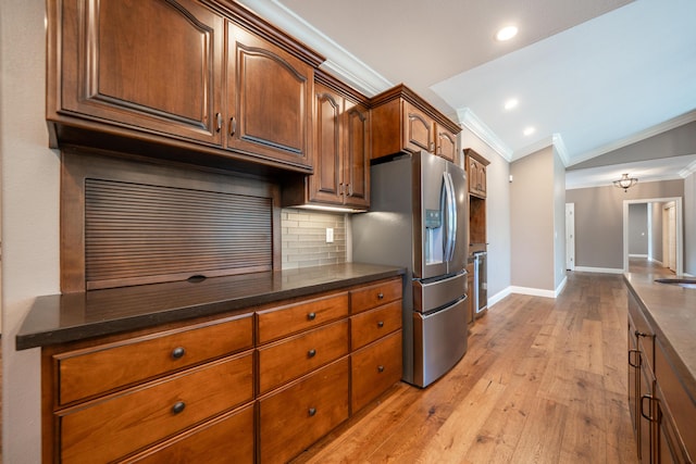 kitchen with stainless steel fridge with ice dispenser, ornamental molding, baseboards, tasteful backsplash, and light wood-style flooring