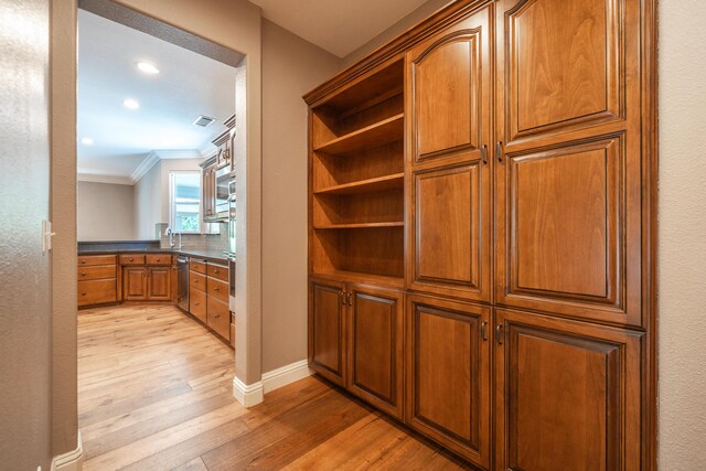 interior space with ornamental molding, wood finished floors, baseboards, recessed lighting, and stainless steel dishwasher