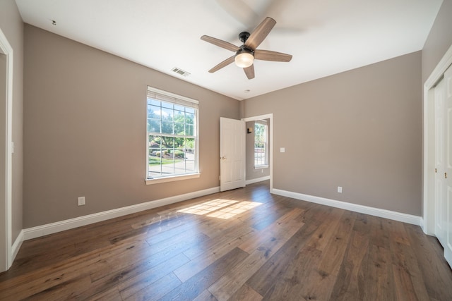 unfurnished bedroom featuring hardwood / wood-style flooring, baseboards, a closet, and ceiling fan