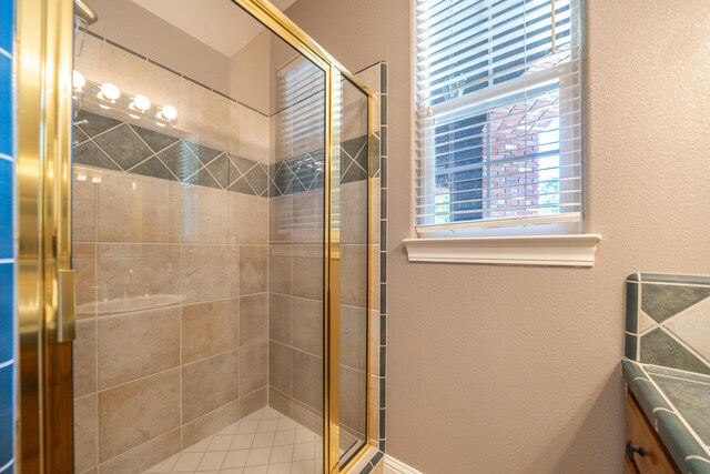 bathroom featuring a shower stall and a textured wall