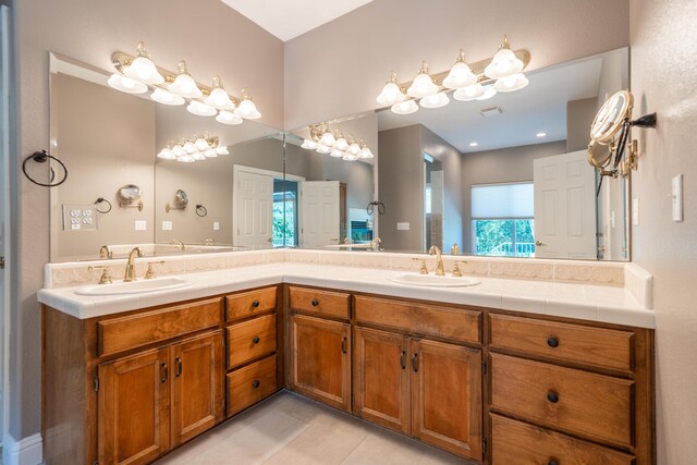 full bath with double vanity and tile patterned floors