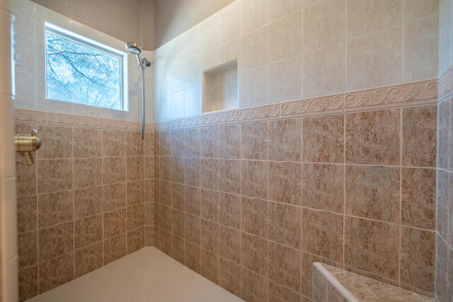 full bathroom with a tile shower