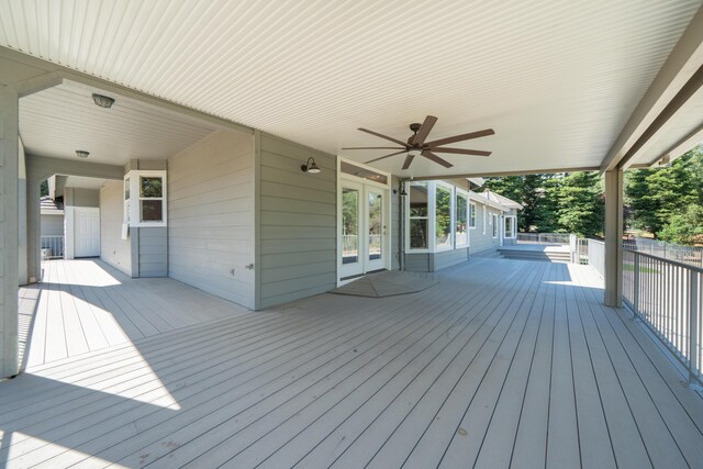 wooden terrace with french doors and a ceiling fan