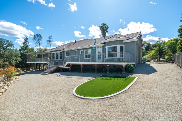 back of house with a wooden deck, fence, a tile roof, and stairs