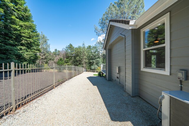 view of home's exterior featuring fence and cooling unit
