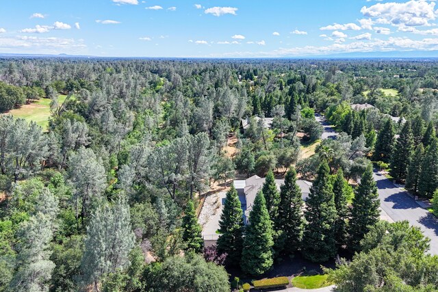 view of property location with a heavily wooded area