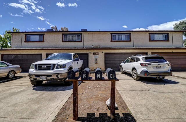 3580 Ricardo Ave, Redding, CA 96002 - view of property with driveway, stucco siding, and an attached garage