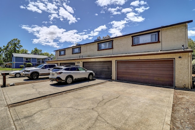 3580 Ricardo Ave, Redding, CA 96002 - multi unit property with concrete driveway, an attached garage, and stucco siding