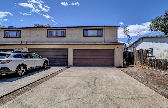 3580 Ricardo Ave, Redding, CA 96002 - townhome / multi-family property featuring concrete driveway, fence, an attached garage, and stucco siding