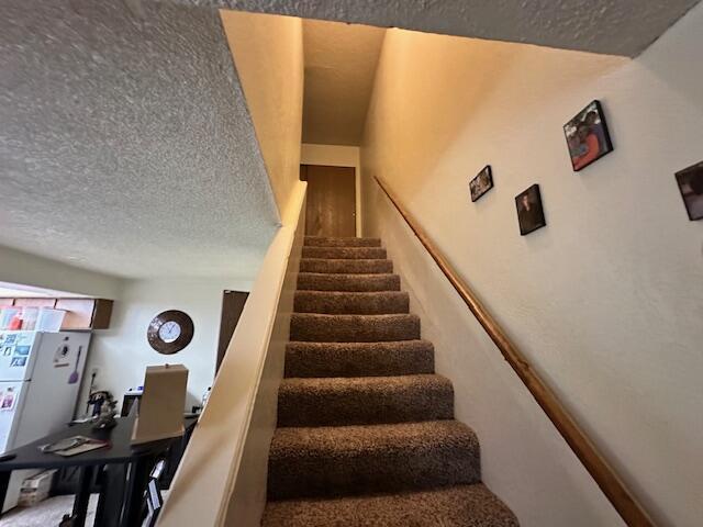 3580 Ricardo Ave, Redding, CA 96002 - staircase featuring a textured ceiling