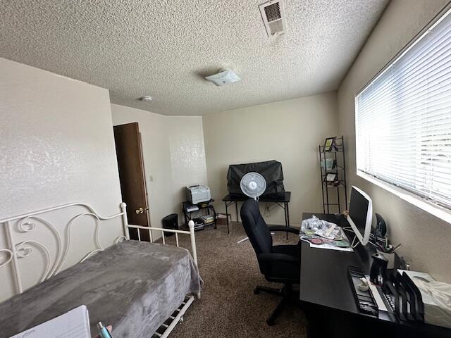 3580 Ricardo Ave, Redding, CA 96002 - carpeted bedroom with a textured ceiling and a desk