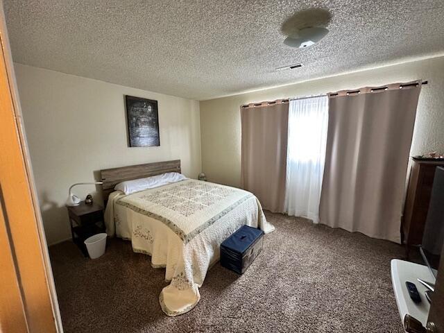 3580 Ricardo Ave, Redding, CA 96002 - carpeted bedroom with a textured ceiling
