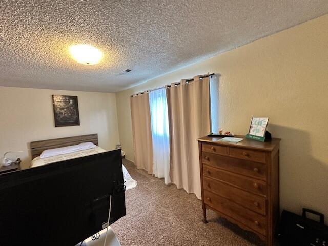 3580 Ricardo Ave, Redding, CA 96002 - bedroom with carpet floors and a textured ceiling
