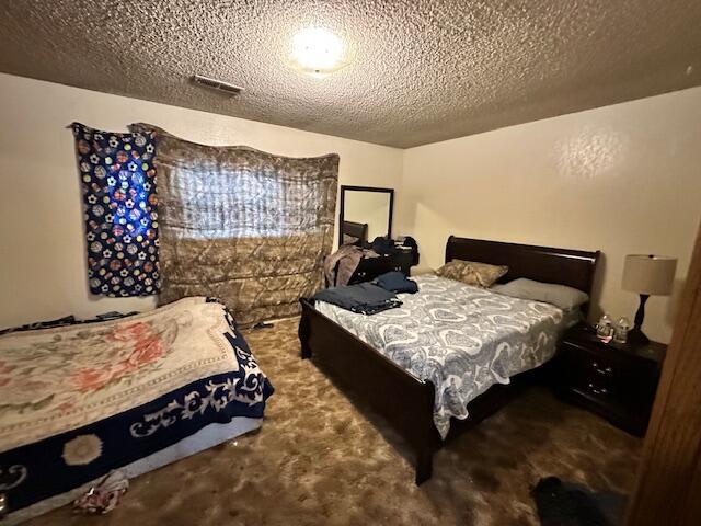 3580 Ricardo Ave, Redding, CA 96002 - carpeted bedroom with a textured ceiling