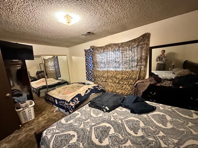 3580 Ricardo Ave, Redding, CA 96002 - carpeted bedroom with a textured ceiling and a closet