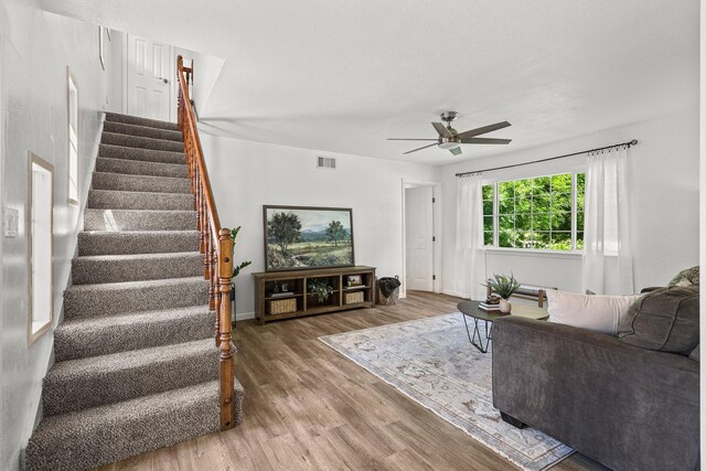 19186 Knighton Rd, Redding, CA 96001 - living area with a ceiling fan, wood finished floors, stairway, and baseboards
