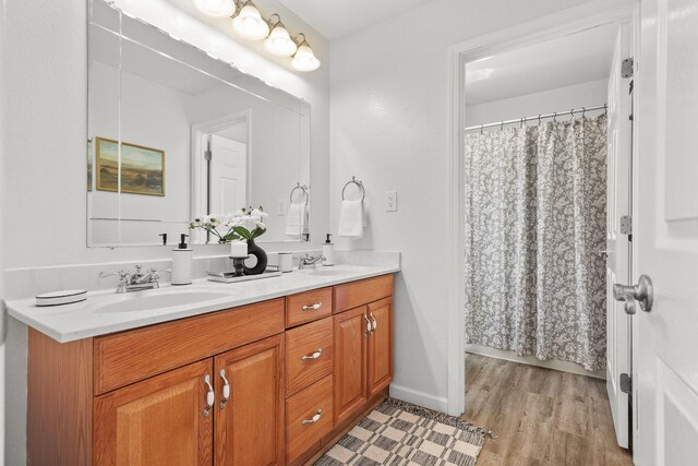 19186 Knighton Rd, Redding, CA 96001 - bathroom with double vanity, wood finished floors, and baseboards