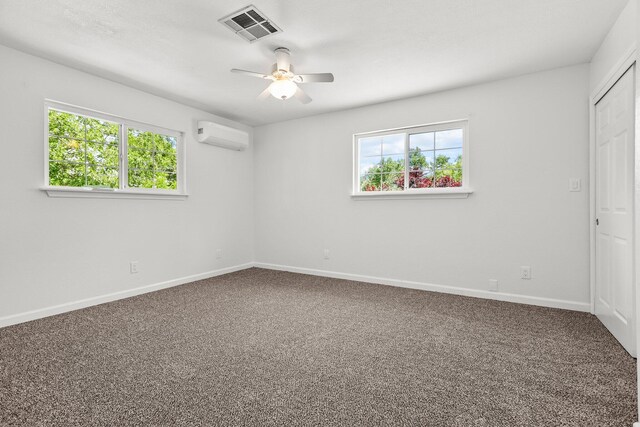 19186 Knighton Rd, Redding, CA 96001 - unfurnished bedroom featuring a wall mounted air conditioner, multiple windows, and carpet