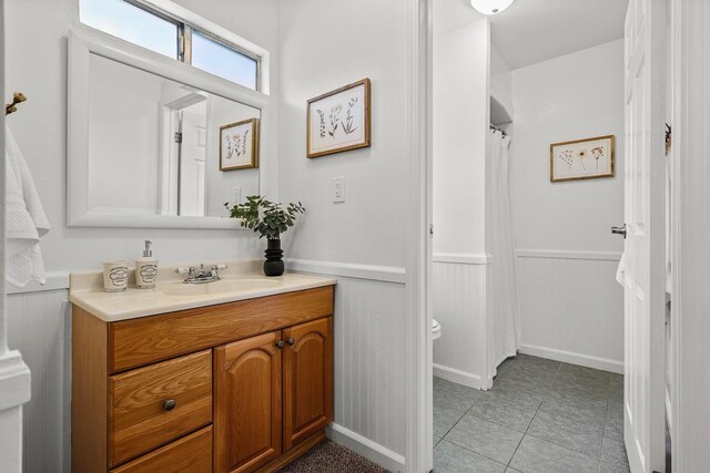 19186 Knighton Rd, Redding, CA 96001 - full bath with wainscoting, vanity, toilet, and tile patterned floors
