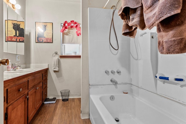 1704 Ashby Rd, Shasta Lake, CA 96019 - full bath featuring vanity, wood finished floors, washtub / shower combination, and baseboards