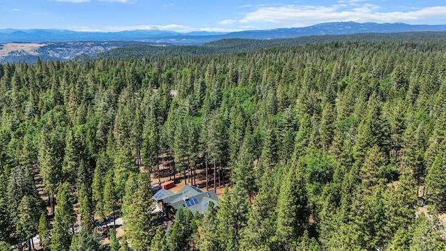 7185 Whispering Winds Ct, Shingletown, CA 96088 - drone / aerial view of a forest and a mountainous background