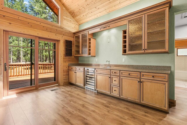 7185 Whispering Winds Ct, Shingletown, CA 96088 - bar with beverage cooler, a sink, vaulted ceiling, wood ceiling, and light wood-style flooring