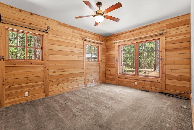 7185 Whispering Winds Ct, Shingletown, CA 96088 - carpeted empty room with ceiling fan and wooden walls