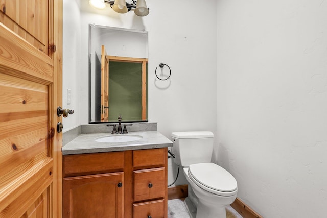 7185 Whispering Winds Ct, Shingletown, CA 96088 - half bath featuring toilet, vanity, baseboards, and a chandelier