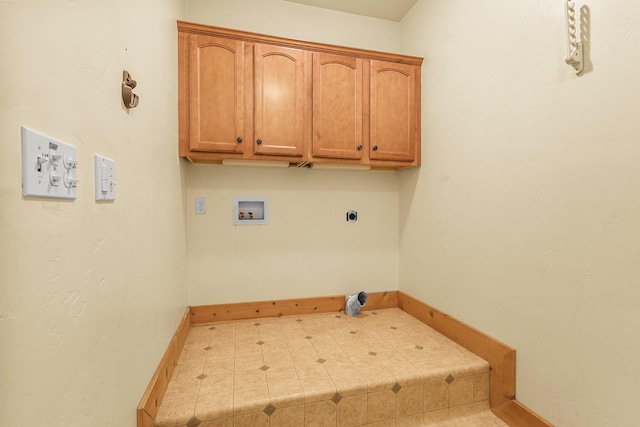 7185 Whispering Winds Ct, Shingletown, CA 96088 - laundry area with cabinet space, baseboards, and electric dryer hookup