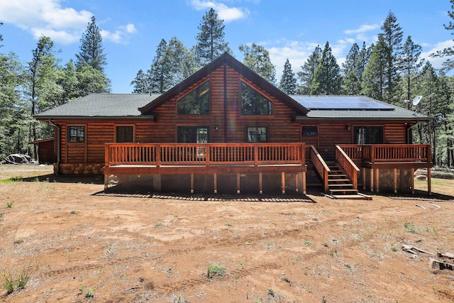 7185 Whispering Winds Ct, Shingletown, CA 96088 - back of house with a deck and roof mounted solar panels
