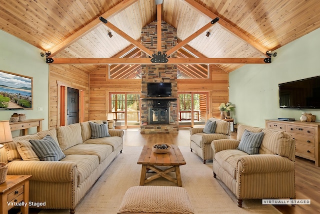 7185 Whispering Winds Ct, Shingletown, CA 96088 - living room with light wood-type flooring, wood walls, high vaulted ceiling, wood ceiling with exposed beams, and a fireplace
