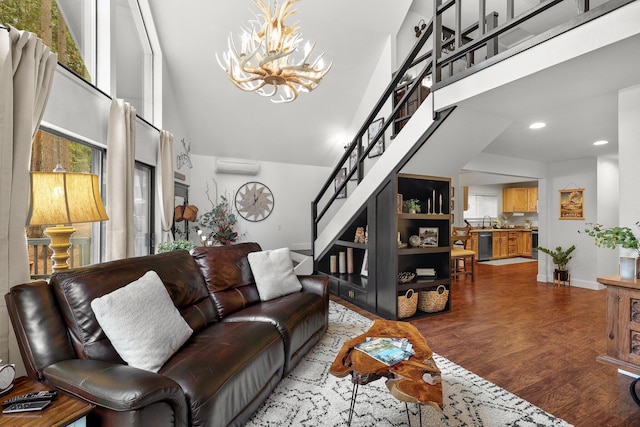 30681 Sleepy Hollow Dr, Shingletown, CA 96088 - living room with a high ceiling, stairs, a chandelier, healthy amount of natural light, and a wall mounted air conditioner
