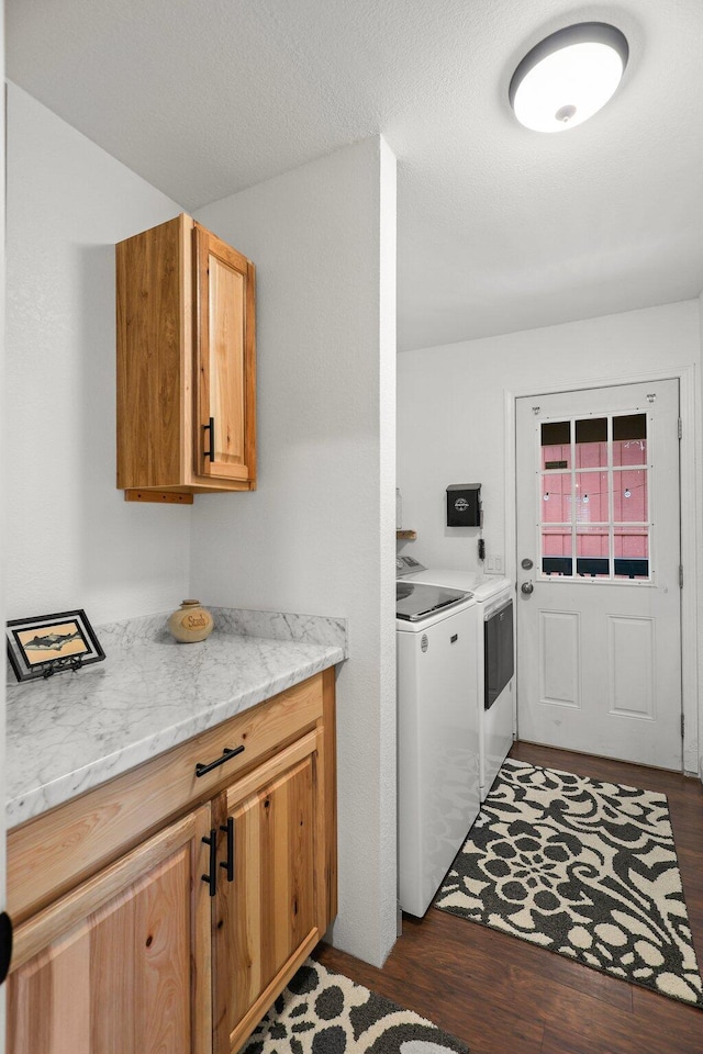 30681 Sleepy Hollow Dr, Shingletown, CA 96088 - washroom featuring separate washer and dryer, dark wood finished floors, and cabinet space