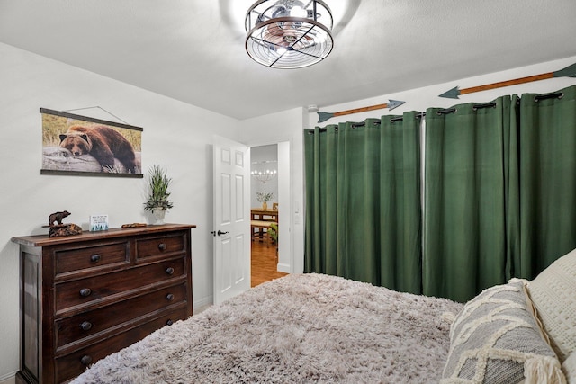 30681 Sleepy Hollow Dr, Shingletown, CA 96088 - bedroom with a chandelier and wood finished floors