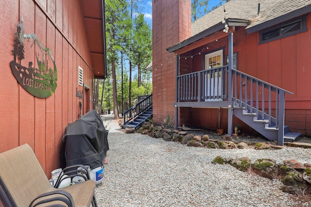 30681 Sleepy Hollow Dr, Shingletown, CA 96088 - view of property exterior with stairs, a chimney, and a shingled roof