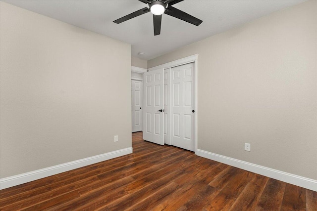 507 Olympic St, Redding, CA 96003 - unfurnished bedroom with baseboards, dark wood-type flooring, a closet, and a ceiling fan