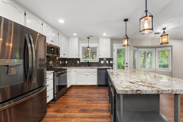 507 Olympic St, Redding, CA 96003 - kitchen featuring stainless steel appliances, a sink, dark wood-style flooring, backsplash, and light stone counters