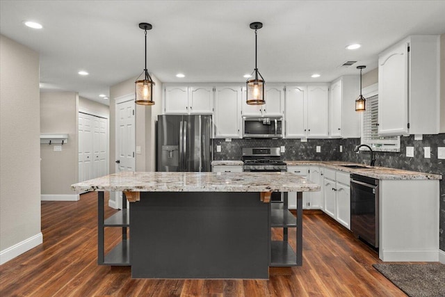 507 Olympic St, Redding, CA 96003 - kitchen featuring stainless steel appliances, baseboards, decorative backsplash, white cabinetry, and recessed lighting
