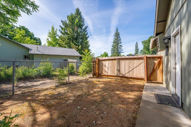 507 Olympic St, Redding, CA 96003 - view of yard with a gate, fence, and a wall unit AC