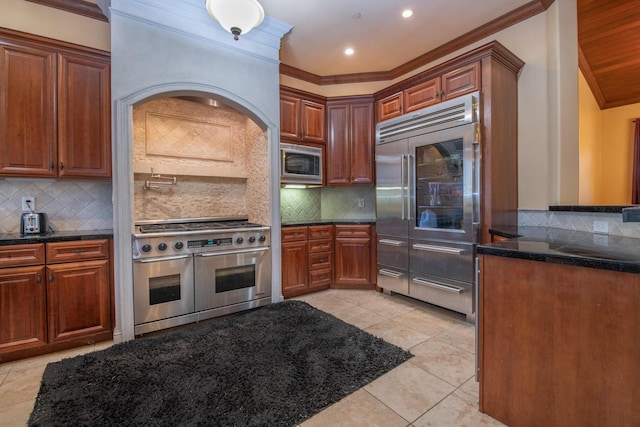 4684 Oak Glen Dr, Redding, CA 96001 - kitchen with built in appliances, crown molding, tasteful backsplash, light tile patterned flooring, and brown cabinetry