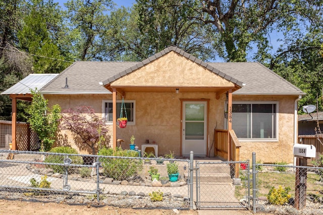 1384 Diamond St, Anderson, CA 96007 - view of front facade featuring stucco siding, a gate, and a fenced front yard