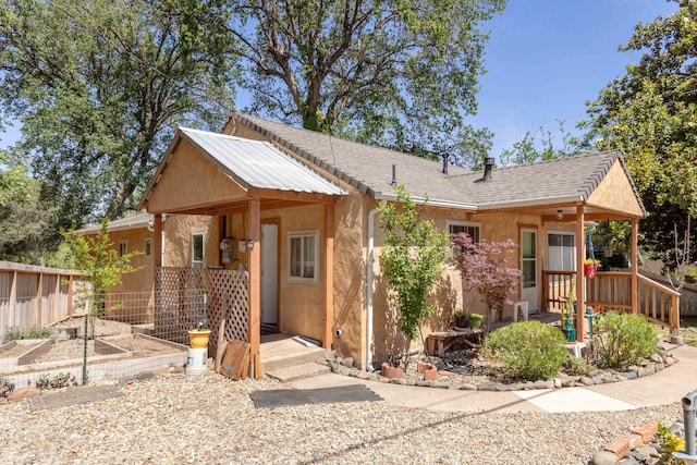 1384 Diamond St, Anderson, CA 96007 - view of front facade featuring a vegetable garden, fence, and stucco siding