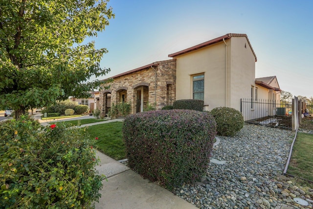 20284 Domaine Pl, Anderson, CA 96007 - view of front facade with stucco siding, fence, and stone siding
