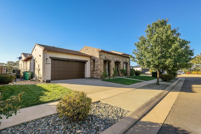 20284 Domaine Pl, Anderson, CA 96007 - view of front of property featuring a garage, driveway, stone siding, stucco siding, and central AC
