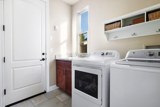 20284 Domaine Pl, Anderson, CA 96007 - laundry room with washing machine and dryer, cabinet space, and light tile patterned floors